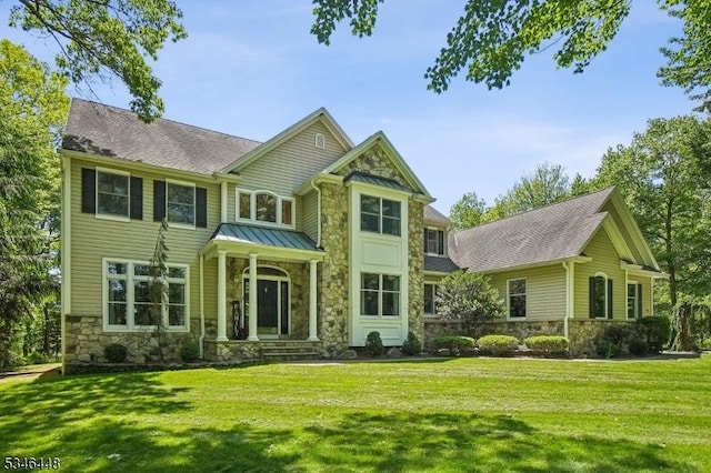 15 Wolfe Run Ct, Washington Twp, NJ 07853 - rear view of house featuring stone siding, a yard, and a standing seam roof