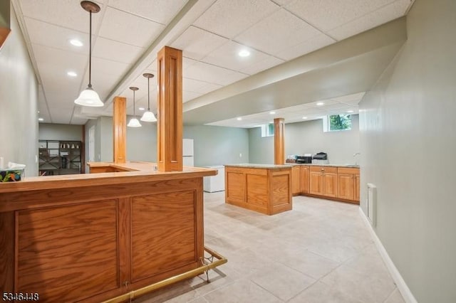 15 Wolfe Run Ct, Washington Twp, NJ 07853 - kitchen with decorative light fixtures, light tile patterned floors, light countertops, a peninsula, and a paneled ceiling