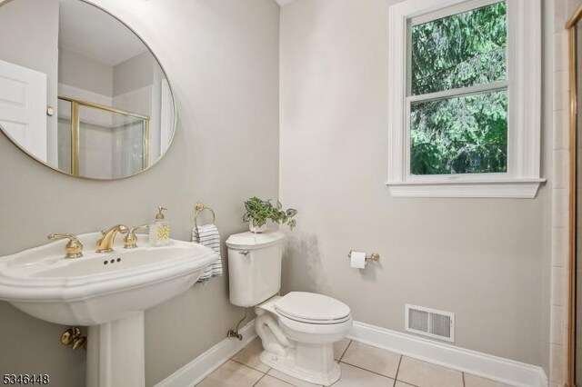 15 Wolfe Run Ct, Washington Twp, NJ 07853 - bathroom with baseboards, tile patterned flooring, toilet, a shower with shower door, and a sink