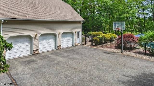 15 Wolfe Run Ct, Washington Twp, NJ 07853 - garage featuring driveway and a gate