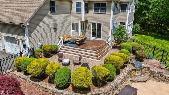 15 Wolfe Run Ct, Washington Twp, NJ 07853 - back of house featuring a fenced backyard, a wooden deck, an outdoor living space, a shingled roof, and a garage