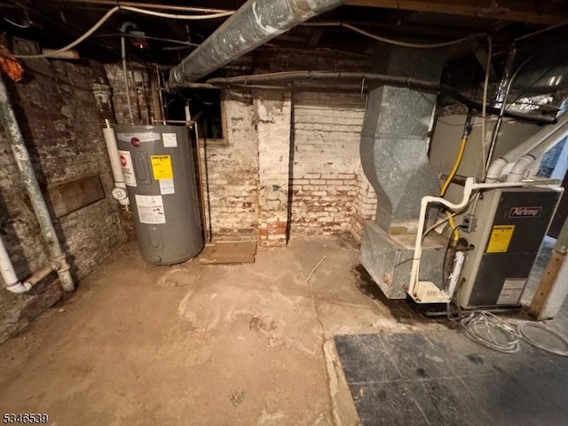 74 Union St, Hackensack City, NJ 07601 - unfinished below grade area featuring electric water heater and heating unit