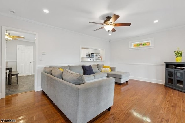 living area featuring crown molding, a ceiling fan, wood finished floors, and recessed lighting