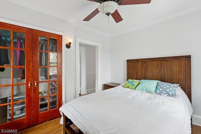 bedroom featuring wood finished floors, crown molding, ceiling fan, and french doors
