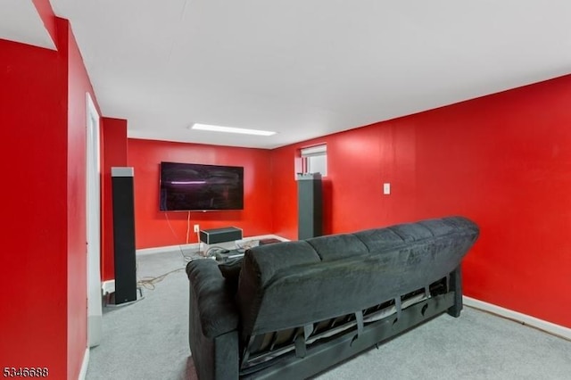 carpeted cinema room with baseboards