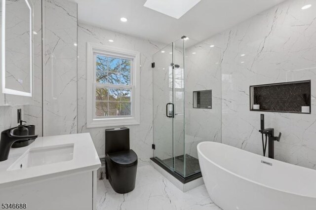 bathroom with marble finish floor, a soaking tub, a marble finish shower, and tile walls