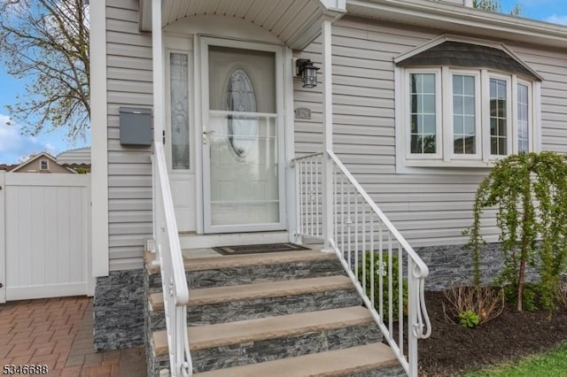 view of exterior entry with fence