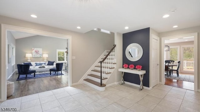 stairway featuring recessed lighting and a wealth of natural light