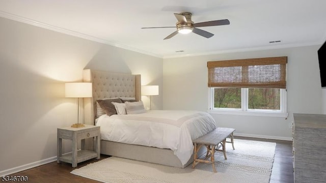 bedroom with crown molding, dark wood-style flooring, baseboards, and a ceiling fan