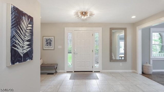 entryway with baseboards, recessed lighting, and tile patterned floors