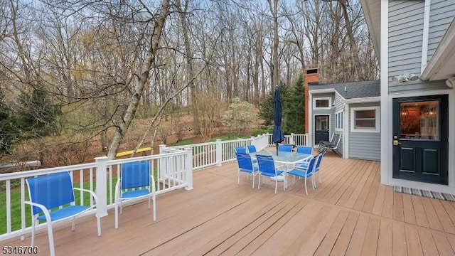 wooden deck featuring outdoor dining space