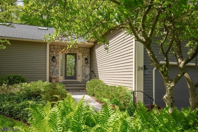 property entrance featuring stone siding