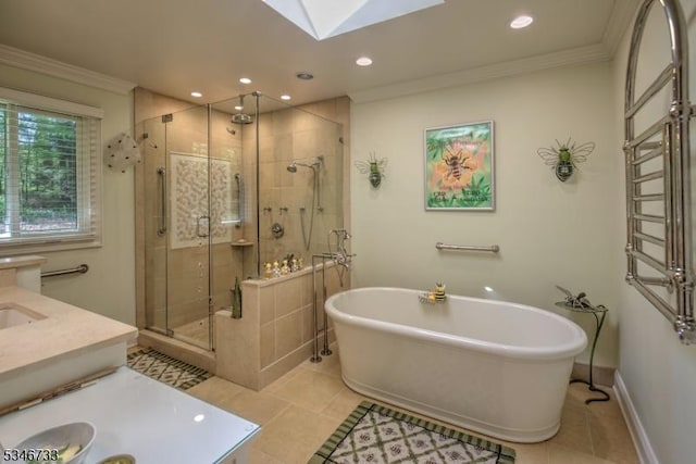 bathroom with crown molding, vanity, recessed lighting, a shower stall, and a skylight