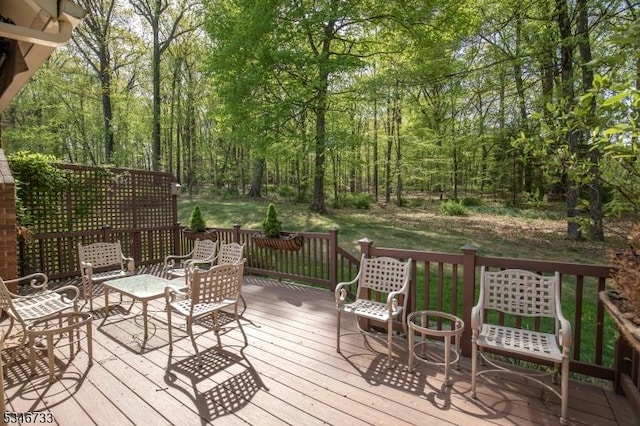 wooden deck featuring a view of trees