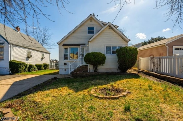 view of front of property with a front lawn and fence