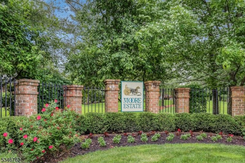 community / neighborhood sign featuring fence