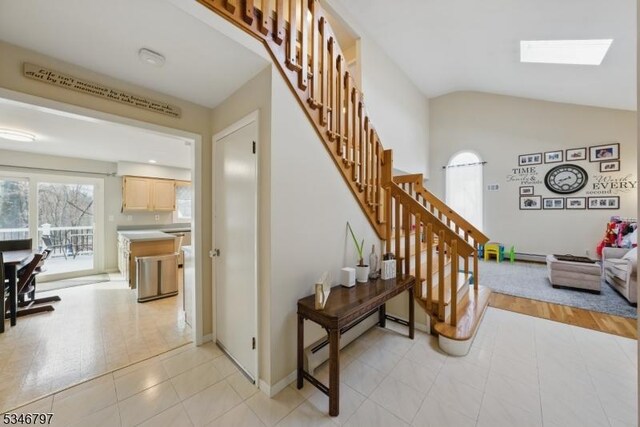100 Toner Rd, Boonton Town, NJ 07005 - staircase featuring lofted ceiling with skylight, baseboards, tile patterned flooring, and baseboard heating