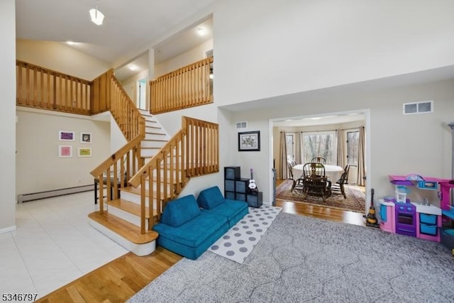 100 Toner Rd, Boonton Town, NJ 07005 - living room with stairs, high vaulted ceiling, visible vents, a baseboard radiator, and wood finished floors