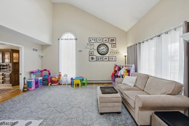 100 Toner Rd, Boonton Town, NJ 07005 - living area with wood finished floors, high vaulted ceiling, a baseboard heating unit, and visible vents