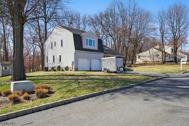 100 Toner Rd, Boonton Town, NJ 07005 - view of side of property with a gambrel roof, driveway, an attached garage, central AC unit, and a lawn