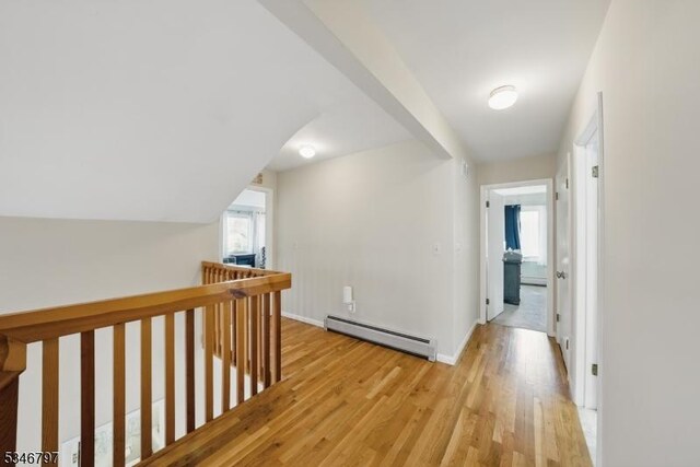 100 Toner Rd, Boonton Town, NJ 07005 - hall featuring an upstairs landing, light wood finished floors, baseboard heating, lofted ceiling, and baseboards