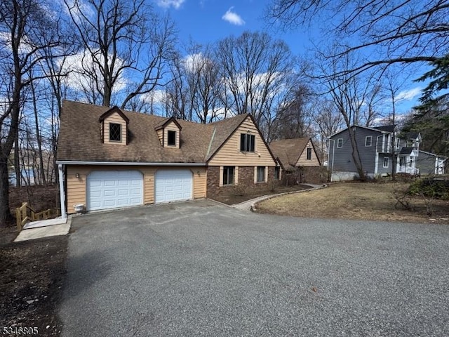 57 Park Rd, Sparta Twp, NJ 07871 - view of front facade with driveway and a garage