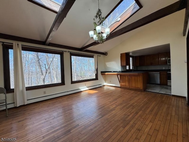 57 Park Rd, Sparta Twp, NJ 07871 - kitchen with a skylight, dark countertops, beamed ceiling, stainless steel appliances, and dark wood-style flooring