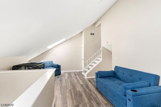 4 Village Way Unit 3, Vernon Twp, NJ 07462 - living area with baseboards, visible vents, wood finished floors, and vaulted ceiling