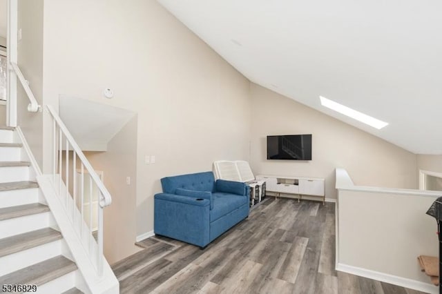 4 Village Way Unit 3, Vernon Twp, NJ 07462 - living room with baseboards, stairs, wood finished floors, and lofted ceiling with skylight