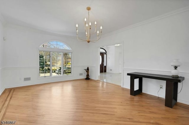 interior space featuring visible vents, crown molding, an inviting chandelier, and light wood-type flooring