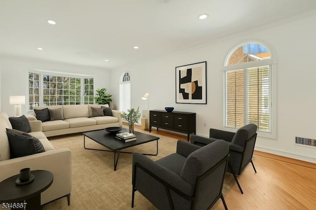 living area featuring light wood-type flooring and recessed lighting