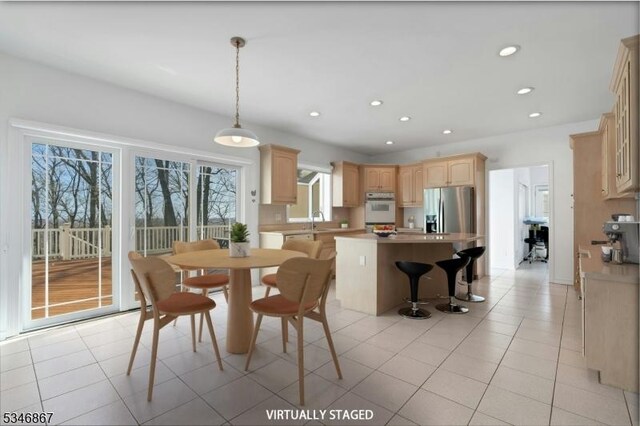 dining area featuring light tile patterned flooring and recessed lighting