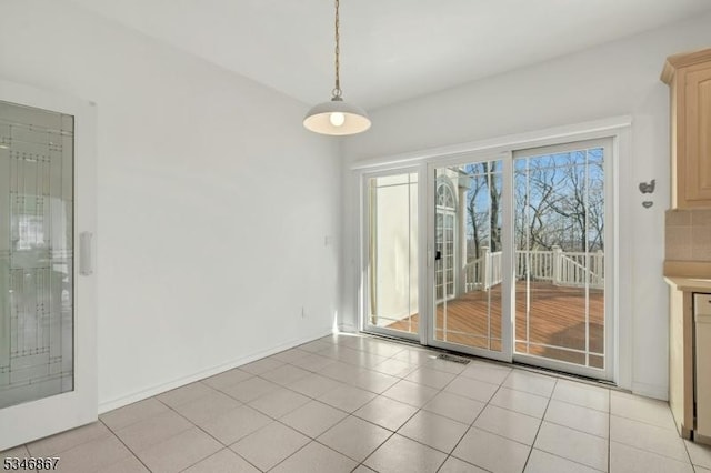 unfurnished dining area with light tile patterned flooring and visible vents