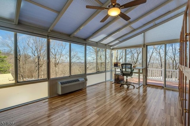 sunroom / solarium with a wall mounted air conditioner, wood finished floors, and ceiling fan