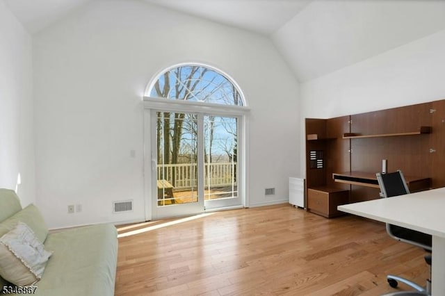 home office featuring high vaulted ceiling, visible vents, and light wood-type flooring