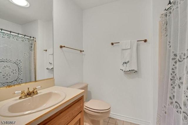 bathroom with toilet, vanity, curtained shower, and tile patterned flooring