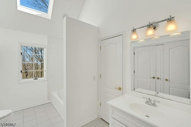 bathroom featuring a closet, toilet, vanity, tile patterned flooring, and baseboards
