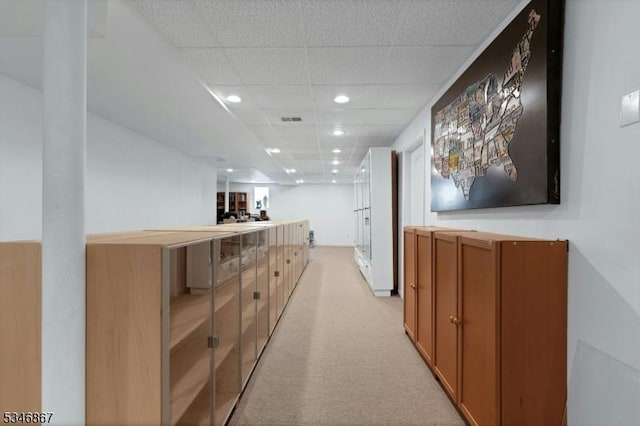 hall featuring light colored carpet, visible vents, recessed lighting, and a paneled ceiling