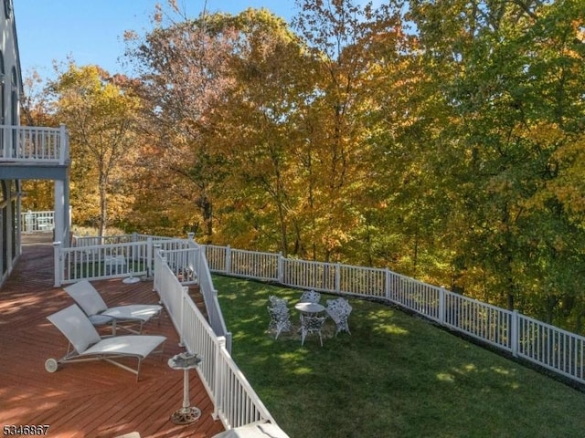 view of yard featuring fence and a deck