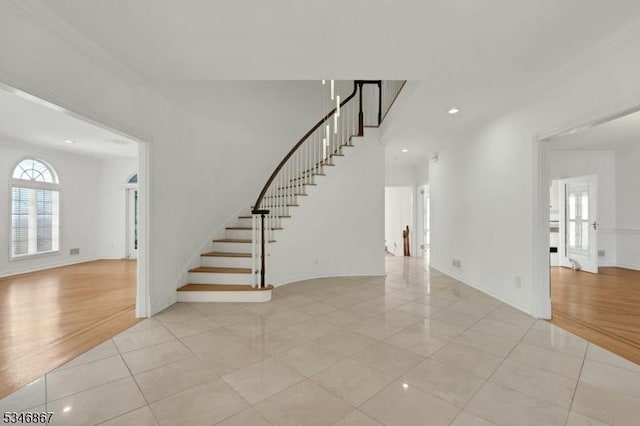 interior space with crown molding, stairway, recessed lighting, light tile patterned floors, and baseboards