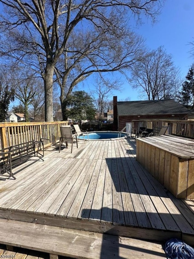 wooden deck featuring a fenced in pool