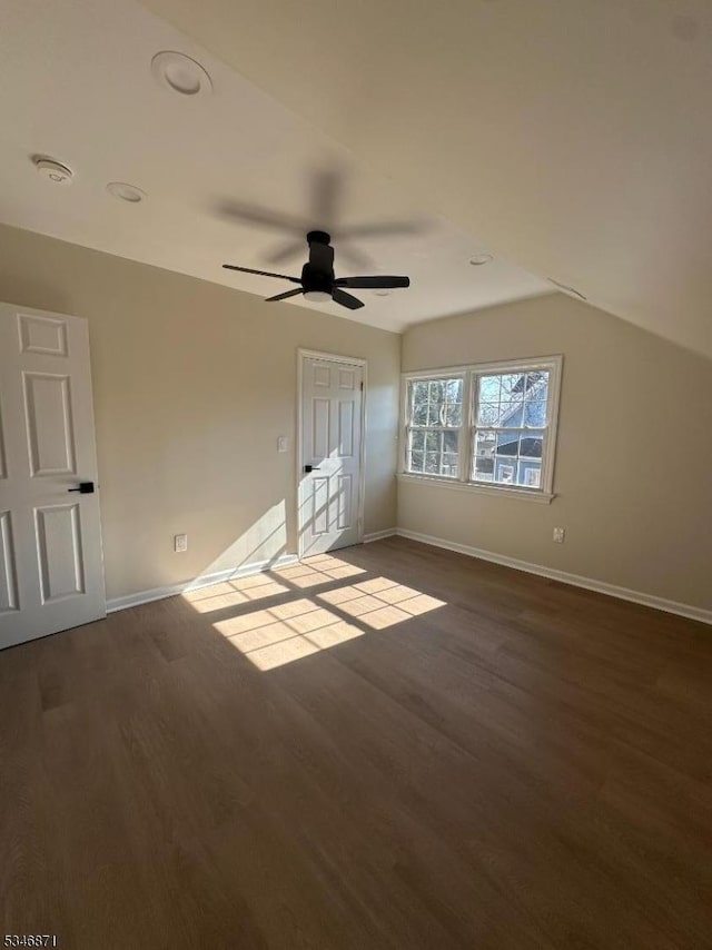 unfurnished bedroom featuring baseboards, dark wood-style floors, and a ceiling fan