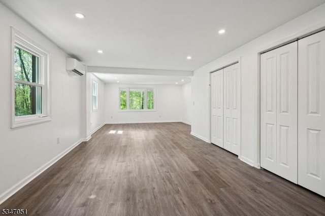 159 Musconetcong River Rd, Lebanon Twp, NJ 07882 - unfurnished bedroom with a wall unit AC, two closets, dark wood-style flooring, baseboards, and recessed lighting