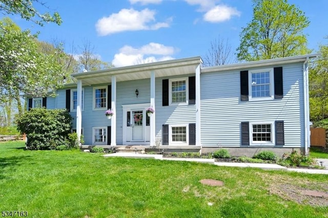 raised ranch with a front yard