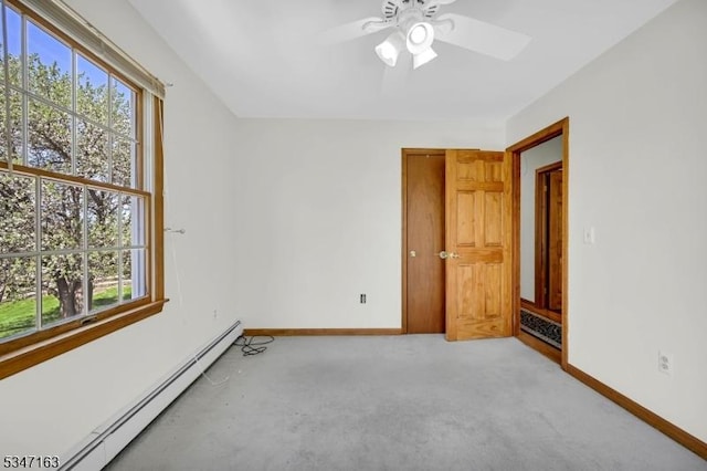 unfurnished room featuring a ceiling fan, baseboards, a baseboard heating unit, and light carpet