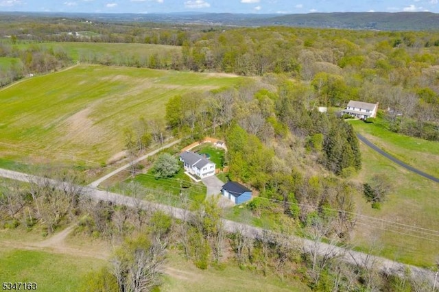 drone / aerial view with a rural view and a wooded view