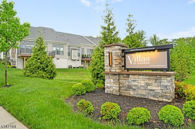 community / neighborhood sign with a lawn