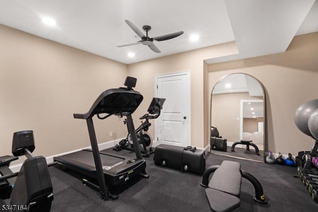 workout room with ceiling fan, recessed lighting, arched walkways, and baseboards
