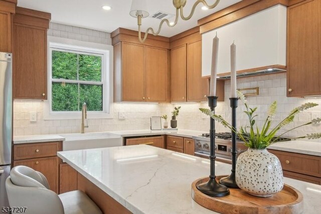 39 Walnut Cres, Montclair Twp, NJ 07042 - kitchen featuring a sink, tasteful backsplash, light stone countertops, brown cabinets, and recessed lighting