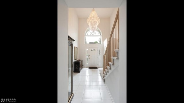 19 Trails End Ct, Westfield Town, NJ 07090 - entryway with a chandelier, light tile patterned floors, stairs, a high ceiling, and baseboards